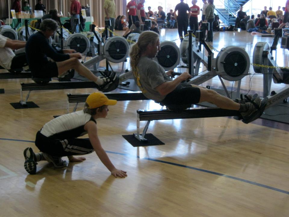 Rowers on ergs at an indoor competition