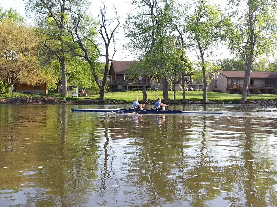 Rowers near houses on the Iowa River